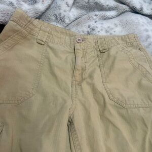 Tan cargo pants with multiple pockets.